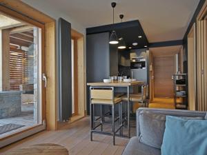 a kitchen and living room with a table and a bar at Appartement Les Arcs 1800, 3 pièces, 4 personnes - FR-1-346-569 in Bourg-Saint-Maurice