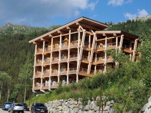 a large wooden building on the side of a hill at Appartement Les Arcs 1800, 3 pièces, 4 personnes - FR-1-346-569 in Bourg-Saint-Maurice