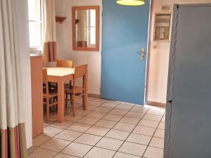 a kitchen with a table and a blue door at Appartement Cerbère, 2 pièces, 4 personnes - FR-1-309-427 in Cerbère