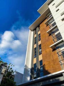 a tall brick building with the sky in the background at Soleil Suites Cebu in Cebu City