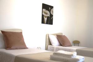 two beds sitting next to each other in a room at BELLA VISTA TROPEA in Tropea