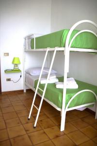 two bunk beds in a room with a lamp at BELLA VISTA TROPEA in Tropea