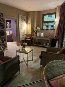 a living room with couches and a coffee table at La Place Boutique Hotel in Antibes