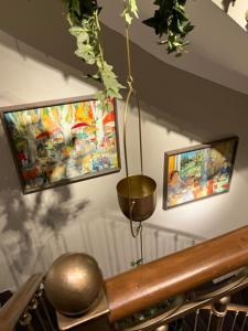 a room with two pictures on the wall and a metal ball at La Place Boutique Hotel in Antibes