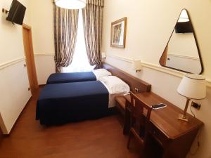 Postel nebo postele na pokoji v ubytování Hotel Mariano