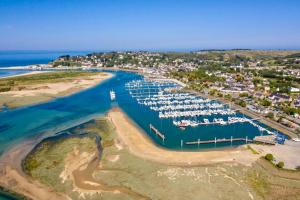 an aerial view of a marina with boats in the water at L'Olivera : entre évasion, sport et nature in Barneville-Carteret