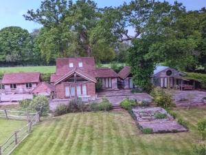 an aerial view of a house with a yard at Prestwick Oak - 2 Luxury Ensuite Doubles - Sleeps 4-6 - Rural Quirky Contemporary in Chiddingfold
