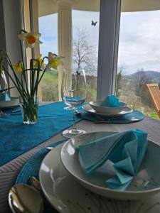 a table with a table set with plates and a glass at House Tereza near Olimje, Podčetrtek in Pristava pri Mestinju