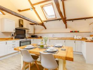 a kitchen with a wooden table and chairs at 2 Bed in Umberleigh 88605 in Chittlehampton