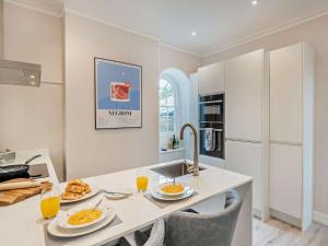 a kitchen with two plates of food on a counter at 1 Bed in Earls Colne 92614 in Earls Colne