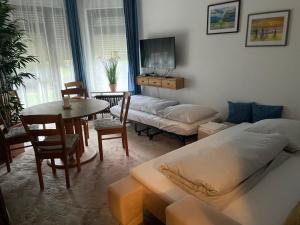 a living room with a bed and a table and a couch at Bernstein in Stuttgart