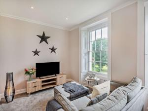 a living room with a couch and two stars on the wall at 1 Bed in Earls Colne 92614 in Earls Colne