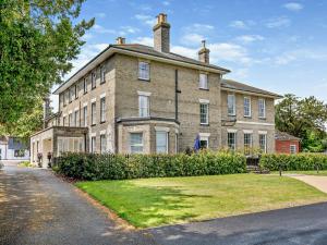 a large brick house with a grass yard in front of it at 1 Bed in Earls Colne 92614 in Earls Colne