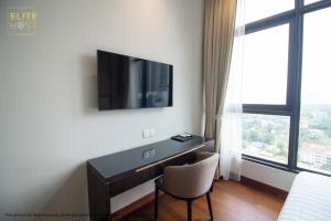 a room with a desk and a tv on a wall at PAVILION EMBASSY KLCC By ELITE HOST in Kuala Lumpur