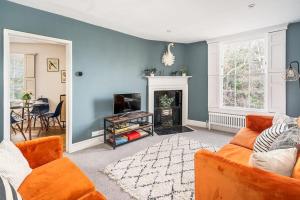 a living room with a couch and a fireplace at Beautiful Central 2 Bed Flat in Bath