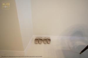 two pairs of shoes sitting on a floor in a room at PAVILION EMBASSY KLCC By ELITE HOST in Kuala Lumpur