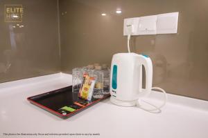 a white appliance sitting on a white counter top at PAVILION EMBASSY KLCC By ELITE HOST in Kuala Lumpur