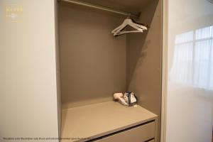 a walk in closet with a phone on a shelf at PAVILION EMBASSY KLCC By ELITE HOST in Kuala Lumpur