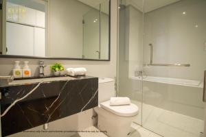 a bathroom with a toilet and a glass shower at PAVILION EMBASSY KLCC By ELITE HOST in Kuala Lumpur