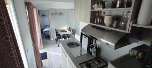 an overhead view of a kitchen with a stove at Franck's tiny house in Lège-Cap-Ferret
