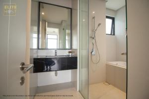 a bathroom with a glass shower stall and a sink at PAVILION EMBASSY KLCC By ELITE HOST in Kuala Lumpur