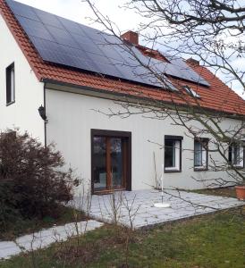 een wit huis met zonnepanelen op het dak bij Urlaub im Grünen in Stahnsdorf