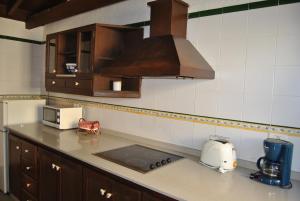 a kitchen with a counter top with a toaster and a microwave at Casa Rural El Cura in Agüimes