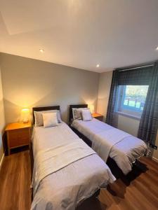 Ένα ή περισσότερα κρεβάτια σε δωμάτιο στο Gleneagles Apartment