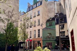 a group of tall buildings on a city street at Serenity, Meditation at Notre Dame in Paris