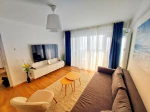 a living room with a couch and a table at Sunflower Sky Apartment in Rijeka