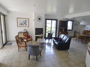 a living room with a couch and chairs and a table at Maison Arzon, 6 pièces, 11 personnes - FR-1-639-29 in Arzon