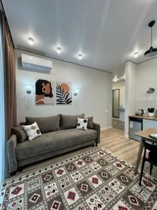 a living room with a couch and a rug at A-Six Apartment luxury in Karagandy