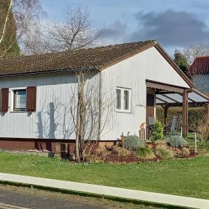 a small white house with a porch at Landhaus Westrich in Walldürn