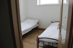 a small room with two beds and a window at Colour in Baku