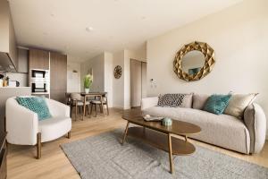 a living room with a couch and a table at London Greenford by Charles Hope in Greenford