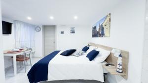 una camera da letto bianca e blu con un letto e un tavolo di Blue Eyes by Ca-Sa Check a Chioggia
