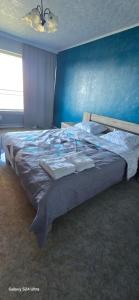 Ένα ή περισσότερα κρεβάτια σε δωμάτιο στο Blue Appartement
