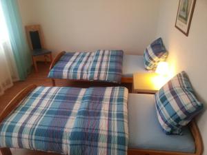 a room with two beds and a table with a lamp at Sweet Home in Friedrichshafen