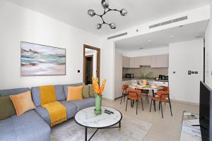 a living room with a couch and a table at New 2 Bedroom in Creek Reserve in Dubai