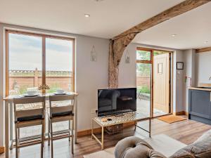 a living room with a fireplace and a tv at 1 Bed in Wix 92565 in Wix