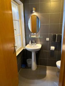a bathroom with a sink and a mirror at Chambres d'Hôtes Le Felseneck in Ferrette