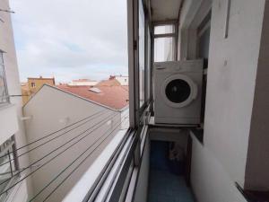 a washing machine on a balcony of a building at VibesCoruña- Marchesi F9 in A Coruña