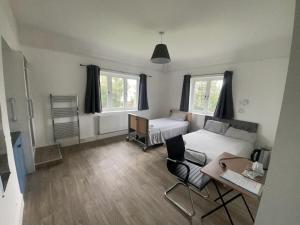 a living room with a bed and a table at Canford house on Westbury on Trym in Bristol