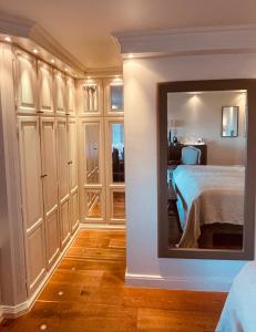 a bedroom with a bed and a mirror at Walters Hof Kampen in Kampen