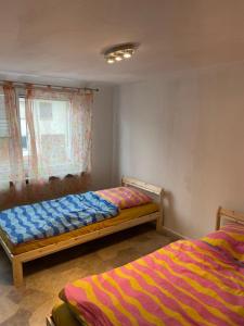 a bedroom with two beds and a window at Haus Dambacher - Arbeiter-Monteurzimmer in Nürtingen