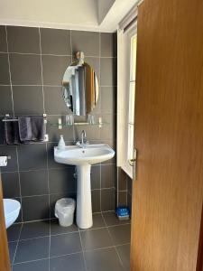 a bathroom with a sink and a mirror at Chambres d'Hôtes Le Felseneck - NOUVEAU PROPRIÉTAIRE - NEW MANAGEMENT in Ferrette