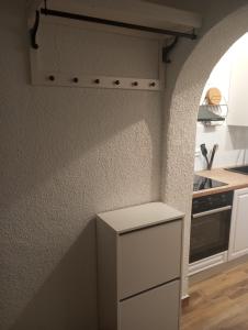 a kitchen with a white refrigerator and a stove at Apartmani Marina in Rab