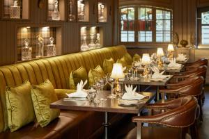 a restaurant with couches and tables and chairs at Old Stable Mews Castle Leslie in Glaslough