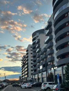 a building with cars parked in a parking lot at Zen Apartment Oradea - FREE Parking in Oradea +14 photos