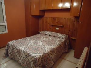 a bedroom with a bed and wooden cabinets at La Coruxa in Los Cabos